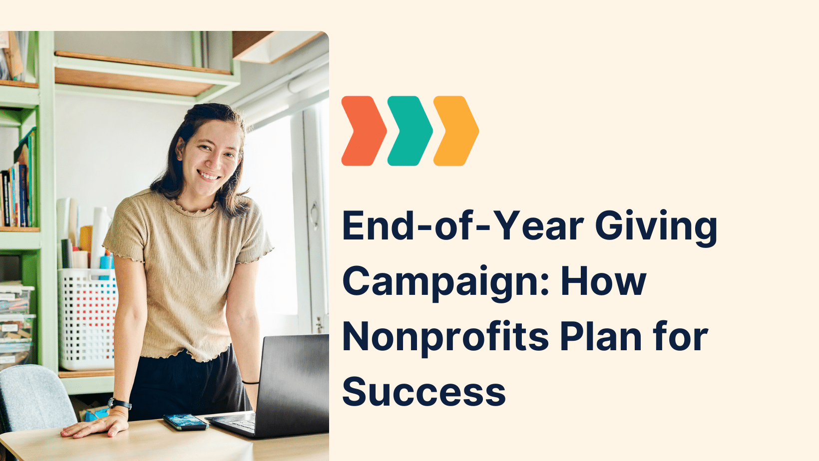 Smiling nonprofit staff member standing by a laptop in a bright office next to a graphic headline that reads “End-of-Year Giving Campaign: How Nonprofits Plan for Success,” illustrating planning for an end-of-year giving campaign.