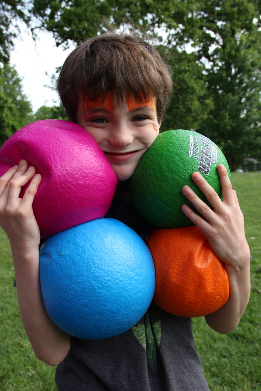 Child holding dodgeballs
