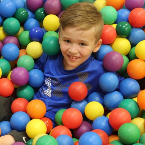 Child in ball pit.